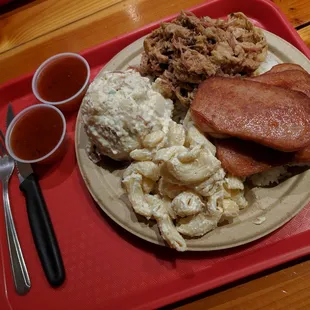 Combo plate with Kalua Pig (pulled pork) and Spam (YUMM isn&apos;t Hawaiian without some spam!) and Hawaiian Mac and Red Potato salad.