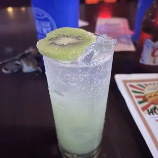 a drink with a kiwi garnish