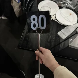 a hand holding a number sign