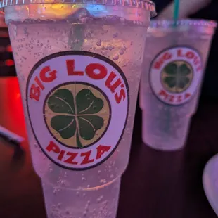 a close up of two cups of soda