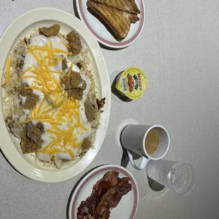 Southern steak breakfast with a side of bacon.