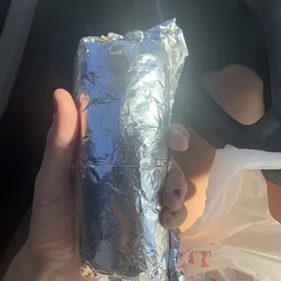 a woman holding a burrito
