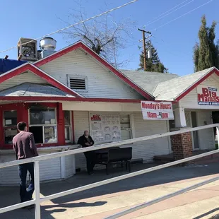 people standing outside of a diner
