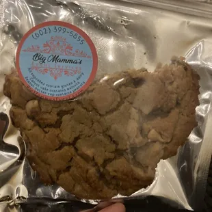 a hand holding a cookie