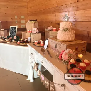 2 tier blush wedding cake and dessert display. We provide the stands and displays when you add dessert to your catered meal.