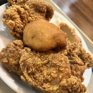 Fried chicken, mashed potato n gravy and a corn bread.