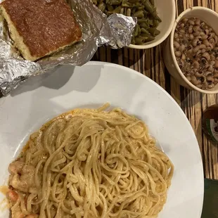 Seafood pasta, black eyed peas, green beans and sweet cornbread.