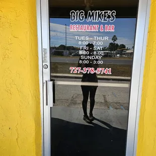 a reflection of a person in the door