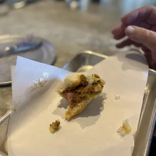 a half eaten sandwich on a tray