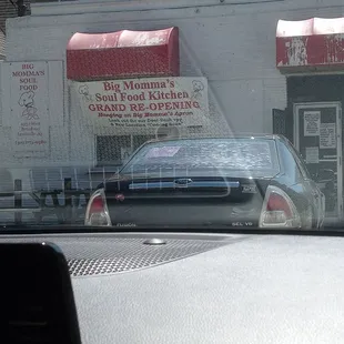 a car parked in front of a restaurant