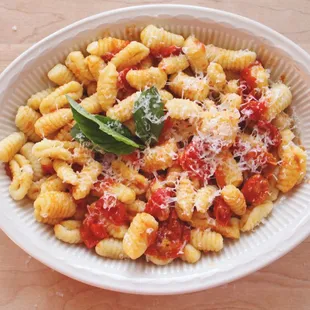 a bowl of pasta with tomato sauce and parmesan cheese