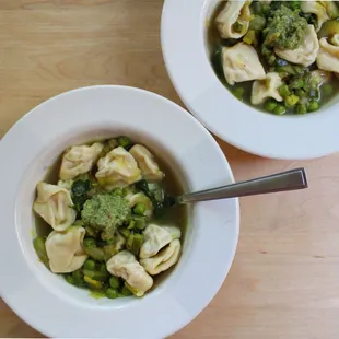 two bowls of soup with broccoli