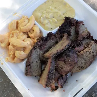 Brisket plate that includes loaded mashed potatoes and nacho mama&apos;s mac.