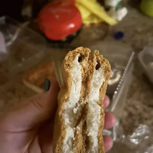 a person holding a half eaten sandwich