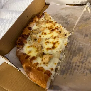 a slice of pizza in a box