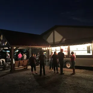 people standing outside at night