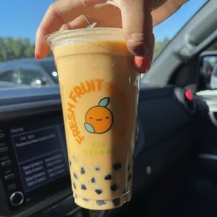 a hand holding a cup of bubble tea