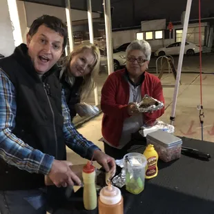 a group of people standing around a table