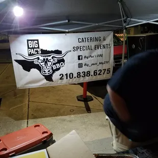 a man preparing food under a tent