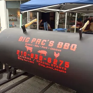 a large bbqq with a hammer sticking out of it