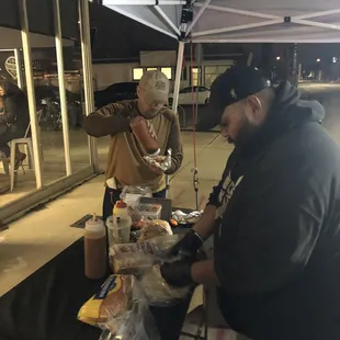 a man serving food to a woman