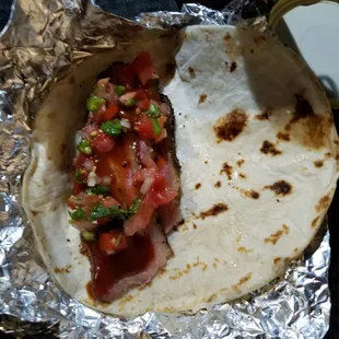 Brisket taco with pico and BBQ sauce.