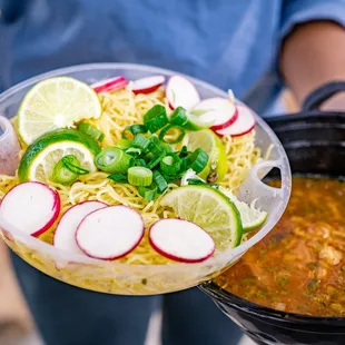 a person holding a bowl of food