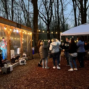 a group of people standing around a tent