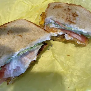 Breakfast sausage, egg, and cheese, tomatoes, and lettuce on Ryebread