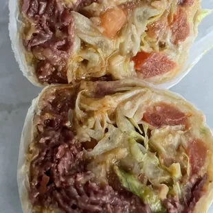 Pastrami, chili cheese, burrito with lettuce and tomatoes