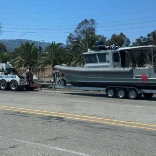 Towing a brand new moose boat to long beach police Dept, notice the gun turret at rear center of boat..without the gun of course..