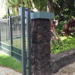 BIG ROCK MOSS ROCK VENEER covering a gate post