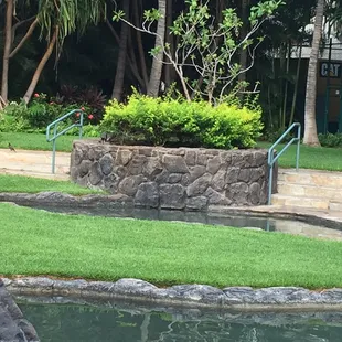 MOSS ROCK Covering a planter, And pond edge. The stone was used extensively throughout the condominiums garden.