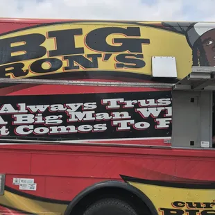 a man standing in front of a food truck