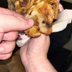 Homemade curly fries all stuck in the shape of the basket