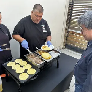 Ruben and his team member serving tacos!