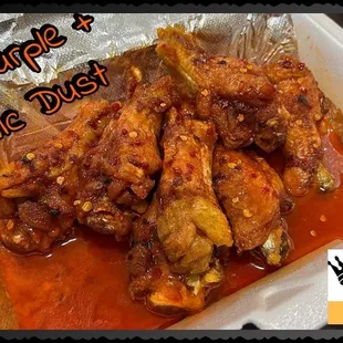 a tray of chicken wings covered in sauce