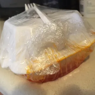 A bit of sauce leaking from the takeout container