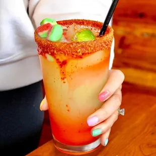 a woman holding a bloody drink