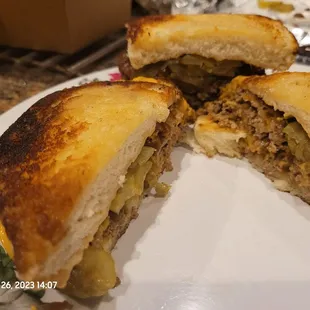 Here, we have a two patty smash burger in the back and a three patty burger cut in half!