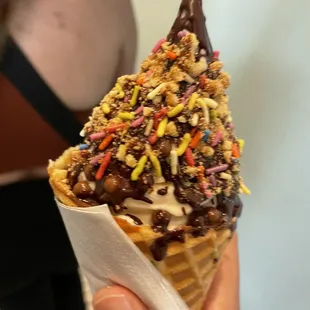 Petite, waffle cone, cantaloupe, chocolate hard shell, peanut butter crumb and chocolate pearls