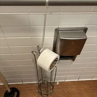 The original toilet paper fixture is not in use, the 2nd toilet paper holder is held up with plastic, which is not sanitary or aesthetic.