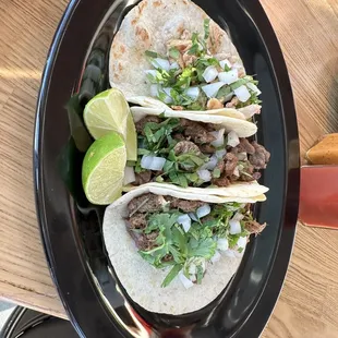 Chicken, steak and barbacoa tacos on flour tortillas