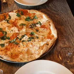 a pizza and a glass of wine