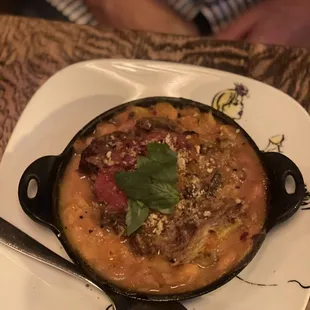 Cassoulet: Cannellini beans, duck confit, braised short rib, Merguez, pork belly chicharrones, topped with shallot confit, panco