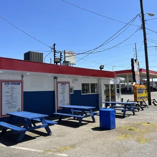 blue picnic tables in a parking lot