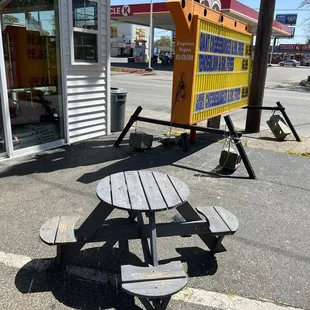 a picnic table in front of a store