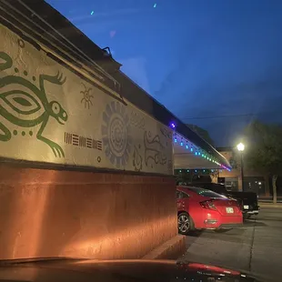 a red car parked in front of a restaurant