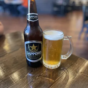 a beer and a glass on a table