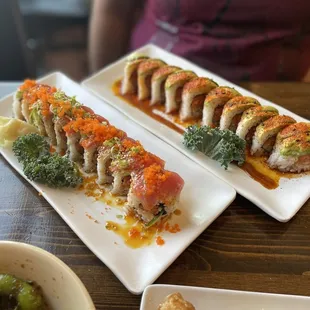 two plates of sushi on a table
